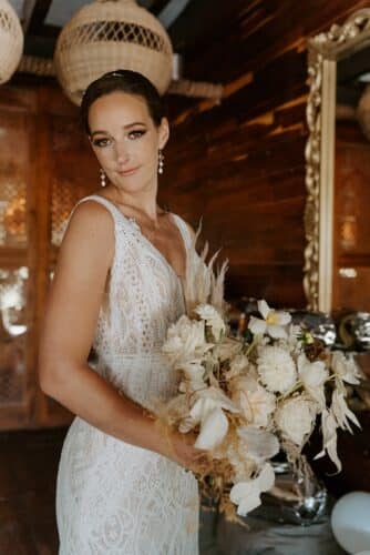 bride standing with wedding flowers